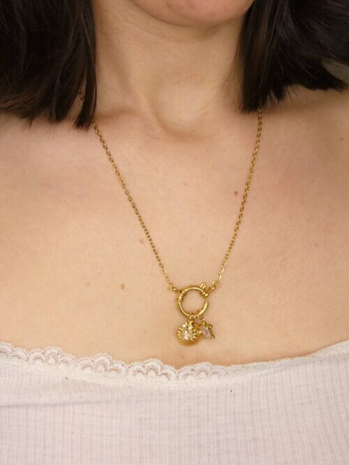 Collier doré avec attache bouée devant à laquelle sont suspendus une breloque crabe, une en forme de coquillage et la dernière en forme de tortue. Bijou en exemplaire unique Sophia Célesta